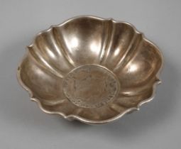Baroque silver bowl with a coin