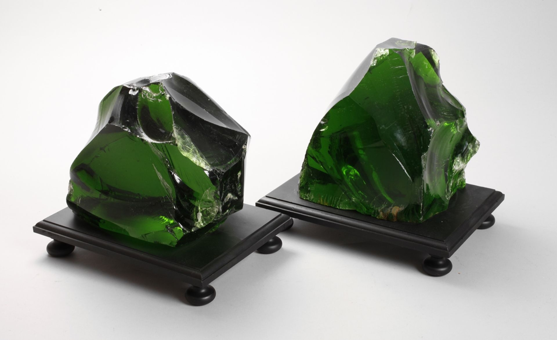 Pair of dark green glass pieces
