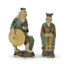TWO JAPANESE ENAMELED TERRACOTTA SCULPTURES DEPICTING A FARMER AND PRIEST. EARLY 20TH CENTURY.