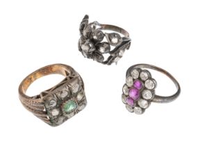 THREE GOLD AND SILVER RINGS WITH RUBIES EMERALDS AND DIAMONDS