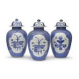 THREE WHITE AND BLUE PORCELAIN JARS WITH LIDS JAPAN 19TH CENTURY. RESTORATIONS TO ONE OF THE LIDS