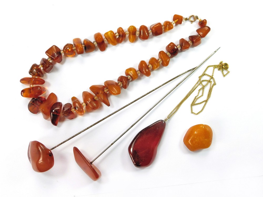 AMBER. Two antique amber specimen hatpins, each pin length 16cm.