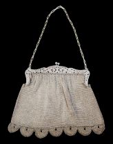 A white metal chain mail opera bag.