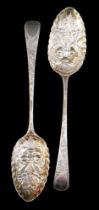 An associated pair of George III silver berry spoons, with blank cartouches, one rubbed maker's