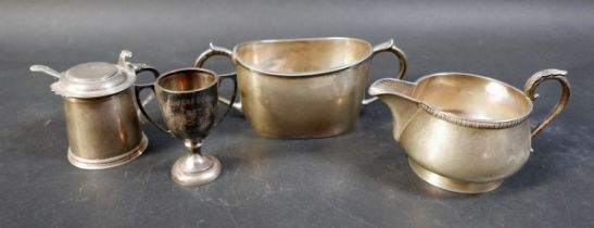A group of four silver items, comprising a milk jug, a sugar bowl, a tankard mustard with plated
