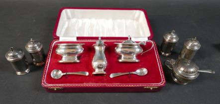 A group of five assorted silver cruet pieces, together with a silver plated cruet set in the form of