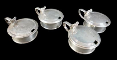 Four William IV and later matched silver mustard pots, including one William IV example, rubbed