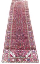 Persian hand knotted runner, red ground, floral decoration, 365 by 100cm.