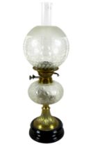 A Victorian paraffin lamp, with etched glass globe shade and clear glass chimney, 17 by 58cm high.