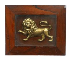 A 19th century gilt metal relief plaque of a lion, lion 14 by 22cm, mounted, glazed and in a