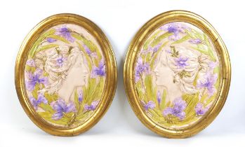 Two Art Nouveau style wall plaques, late 20th century, depicting two female profiles, with gold oval