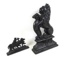 A 19th century cast-iron figure of a rampant lion, 26cm by 39cm, and a smaller cast-iron group, 20cm