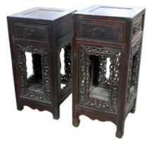 A pair of Chinese carved vase stands with a single drawer and carved panels, 40 by 43 by 88cm