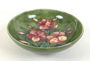 A William Moorcroft fruit bowl, mid 20th century, decorated in the 'Freesia' pattern, 31cm by 9.