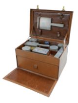 A 1930's pigskin leather travel box with six silver top bottles, a mirror and two brushes hallmarked