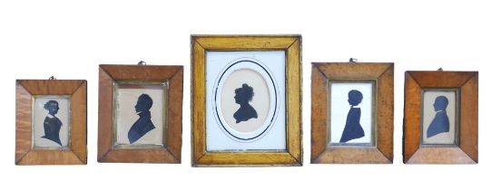 Five 19th century silhouette portraits, including an oval mounted portrait with text verso '. M.
