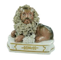 A 19th century Staffordshire lion and lamb figurine, each with gilt decoration to its base, 12.5