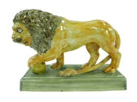 An 18th century or later Staffordshire figurine modelled as a Medici lion, in naturalistic