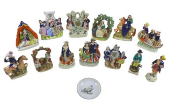 A collection of thirteen Staffordshire figures and groups, including three watch holders, together