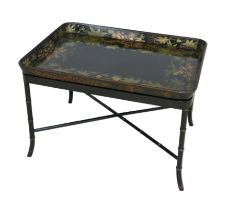 A late Victorian painted tole, ebonised and gilt work tray top table, decorated with leaves, on a