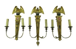 Three 19th century giltwood and gesso wall sconces, each eagle surmounts, one with a ball and