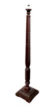 A Georgian mahogany spiral carved standard lamp, with a square carved stepped base, made from a