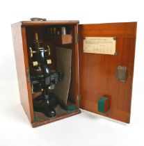 A Charley Perry of London microscope with mahogany case and accessories.