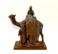 A cast metal sculpture, in the style of Franz Bergmann, modelled as a Persian rug seller, with camel