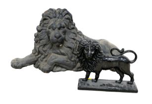 A cast iron figure, in the form of a recumbent lion, 65 by 36cm high, together with a cast iron door