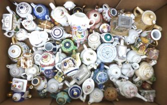 A quantity of miniature teapots, most ceramic, many by Porcelain Art, along with a quantity of