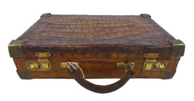 An early 1900s crocodile attache case with a fitted interior, 36cm by 23cm by 9.5cm tall With