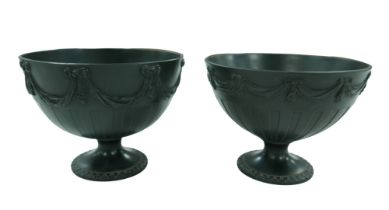 A pair of 19th century Wedgwood basalt bowls, each decorated with swags above a fluted body,