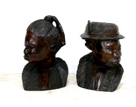 A pair of African hardwood carved sculptures, modelled as a woman, 55cm and man wearing a hat,
