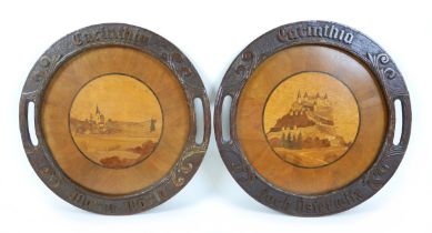 A pair of Edwardian marquetry inlaid bread platters / trays, each 37cm diameter. (2)