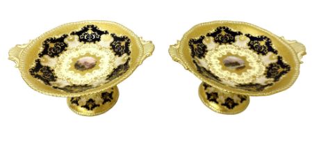 Two Coalport china twin handled comports, shape / pattern X1995, painted with a central reserve of a