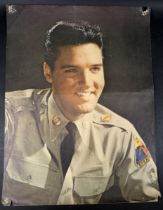 Elvis Presley 1950’s poster print, wearing US Army uniform, 81 by 40cm, together with a film