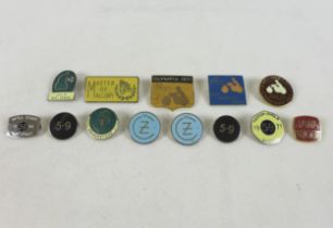 A group of twelve vintage motorcycling badges.