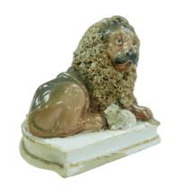 A 19th century Staffordshire lion and lamb figurine, each with gilt decoration to its base, 12.5