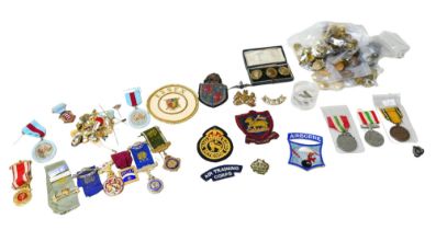 A collection of 20th century military badges and buttons, including two WWII Defence medals,