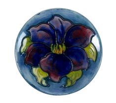 A Moorcroft pin dish, circa 1940, tube lined with a blue anemone, impressed factory mark and