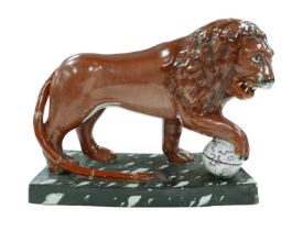 A 18th century or later Staffordshire figurine modelled as a Medici lion, sangue de boeuf glazed