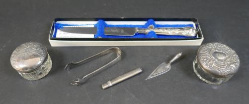 A group of silver, including a silver mounted pencil, a trowel form paperclip, two silver lidded