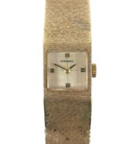 A vintage Gerrards 9ct gold lady's wristwatch, square gold dial, black and gold batons and hands,