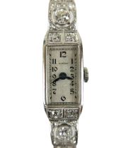 An Art Deco Eszeha platinum and diamond set lady's cocktail wristwatch, the rectangular silvered