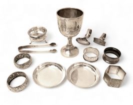 A collection of silver items, to include an engraved sporting cup, 1931, 12cm high, a three footed