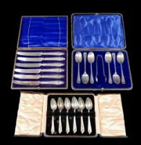 Two boxed sets of six silver tea spoons, one with nips and a boxed set of six silver handled knives.