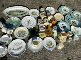 A collection of fish plates, mugs etc
