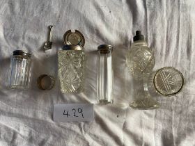 A collection of silver topped and other bottles and jars
