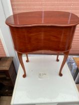 A kidney shaped sewing table