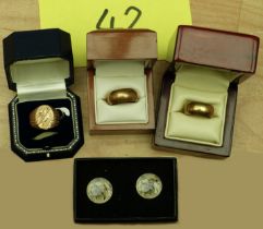 Three yellow metal rings, and a pair of cufflinks decorated with a WWII plane.